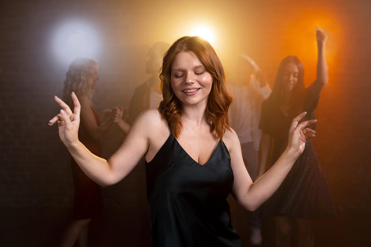 medium-shot-smiley-woman-dancing copy